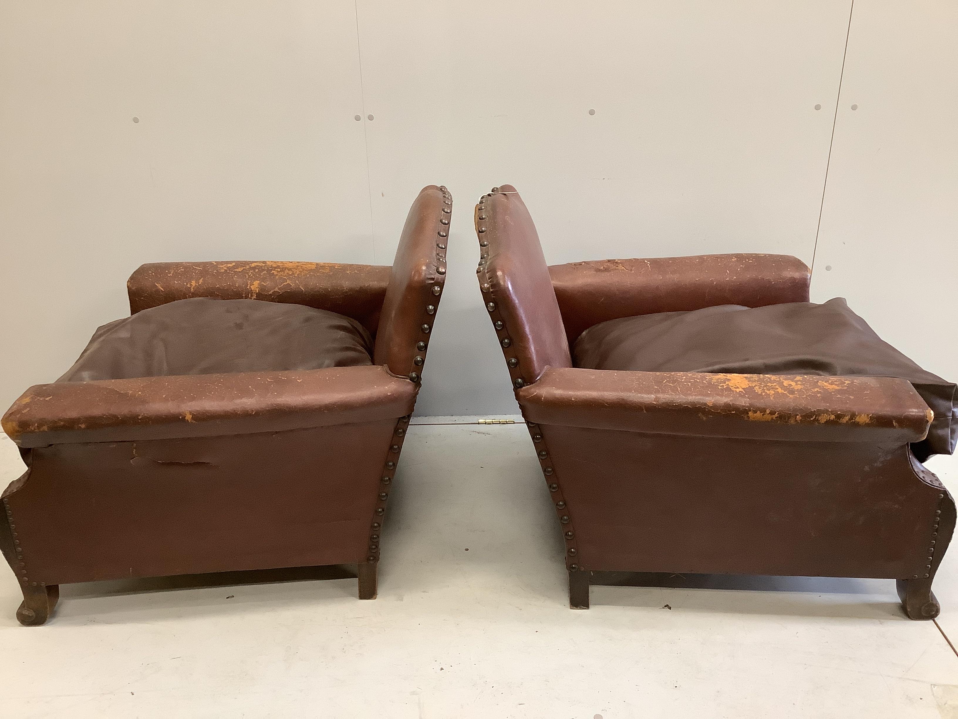 A pair of early 20th century French brown leather studded club chairs, width 84cm, depth 84cm, height 82cm